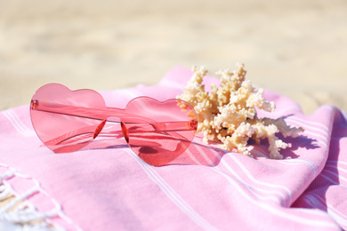 Photo of Stylish beach accessories for summer vacation on sand, closeup
