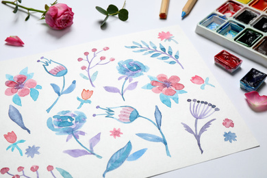 Photo of Composition with floral picture and watercolor paints on white background