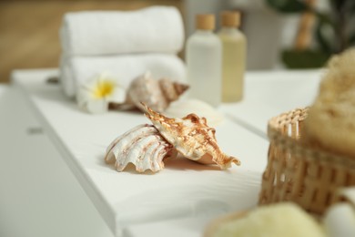 Photo of Bath tray with shells on tub in bathroom, closeup