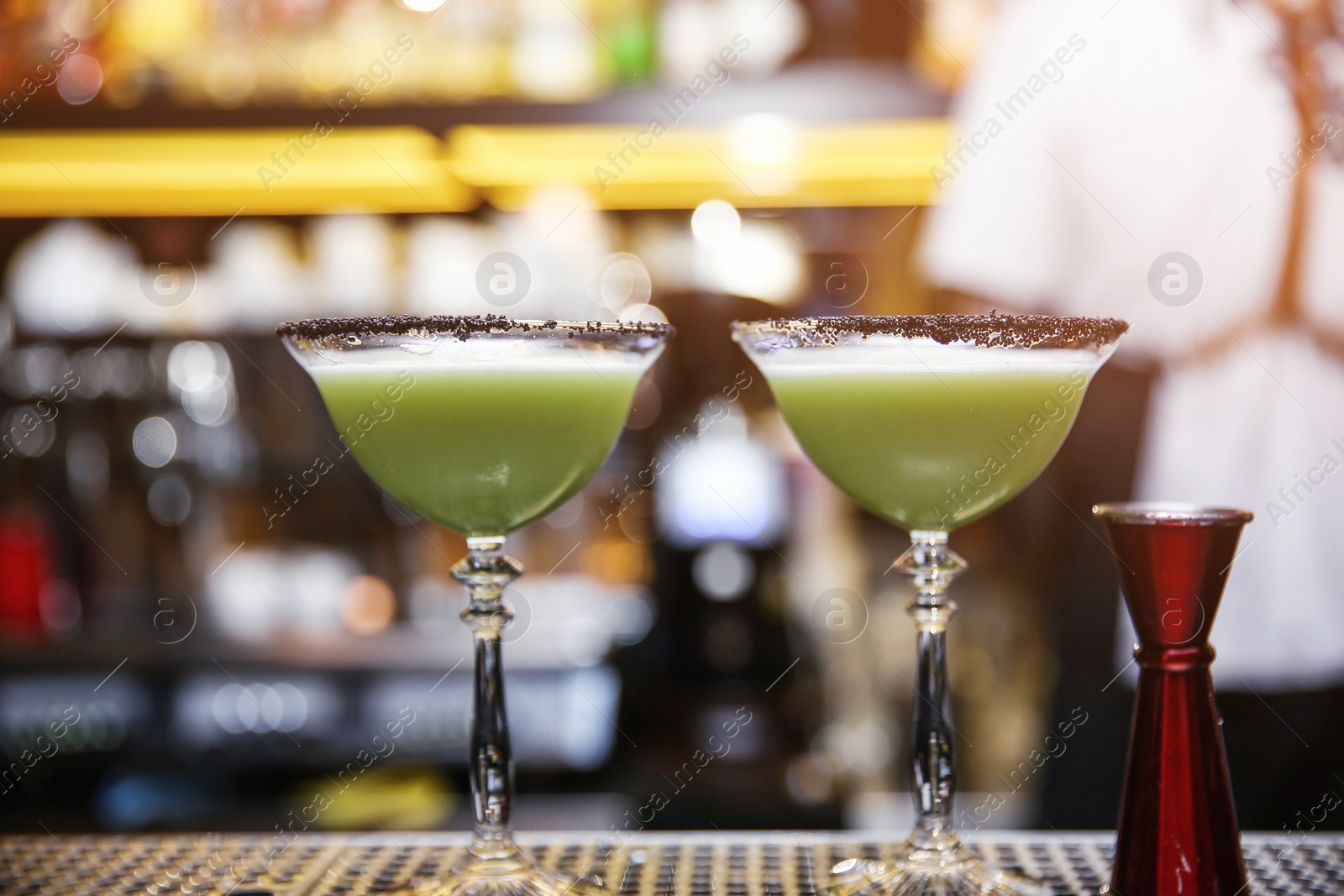 Photo of Glasses of tasty cocktail on bar counter