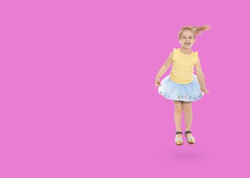 Image of Cute girl jumping on pink background, space for text