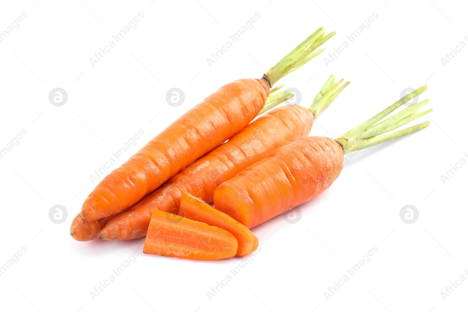Cut and whole ripe carrots isolated on white Photo of Cut and whole ripe carrots isolated on white
