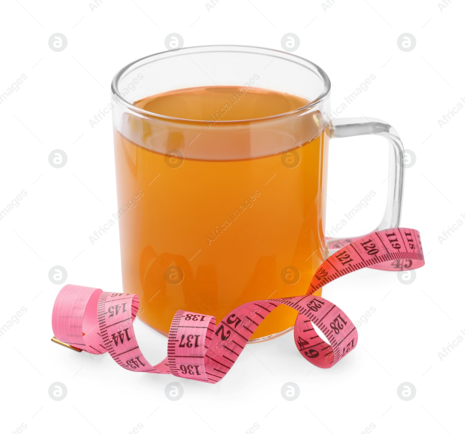 Photo of Glass cup of diet herbal tea and measuring tape on white background. Weight loss