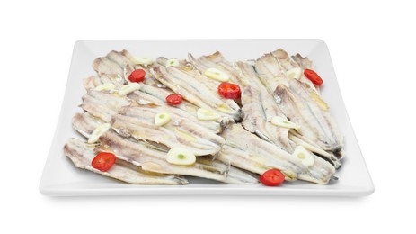 Photo of Tasty pickled anchovies with garlic and chili pepper isolated on white