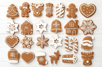 Many different delicious Christmas cookies on white wooden table, flat lay