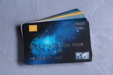 Photo of Credit cards on grey textured table, top view