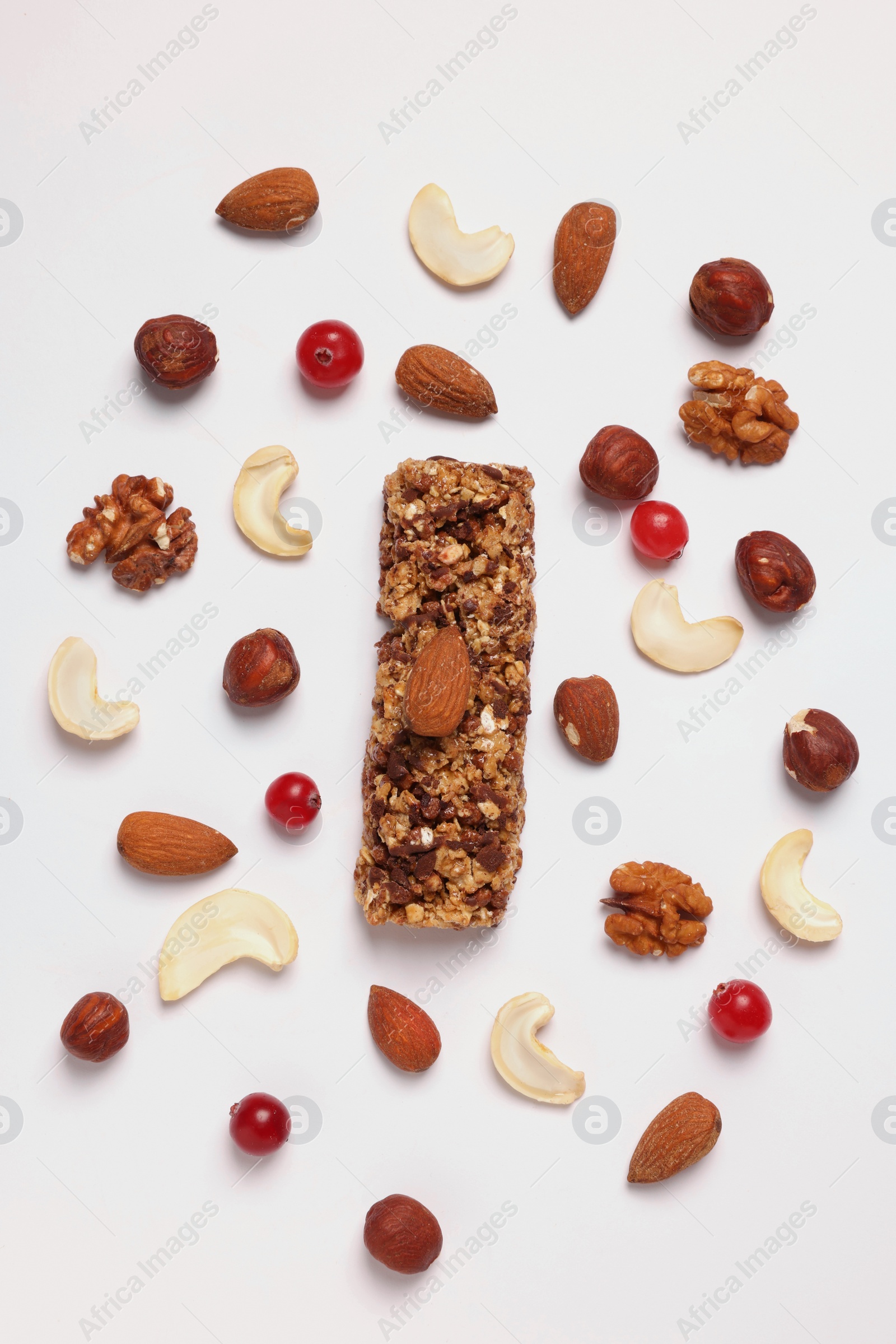 Photo of Tasty granola bar and ingredients isolated on white, top view