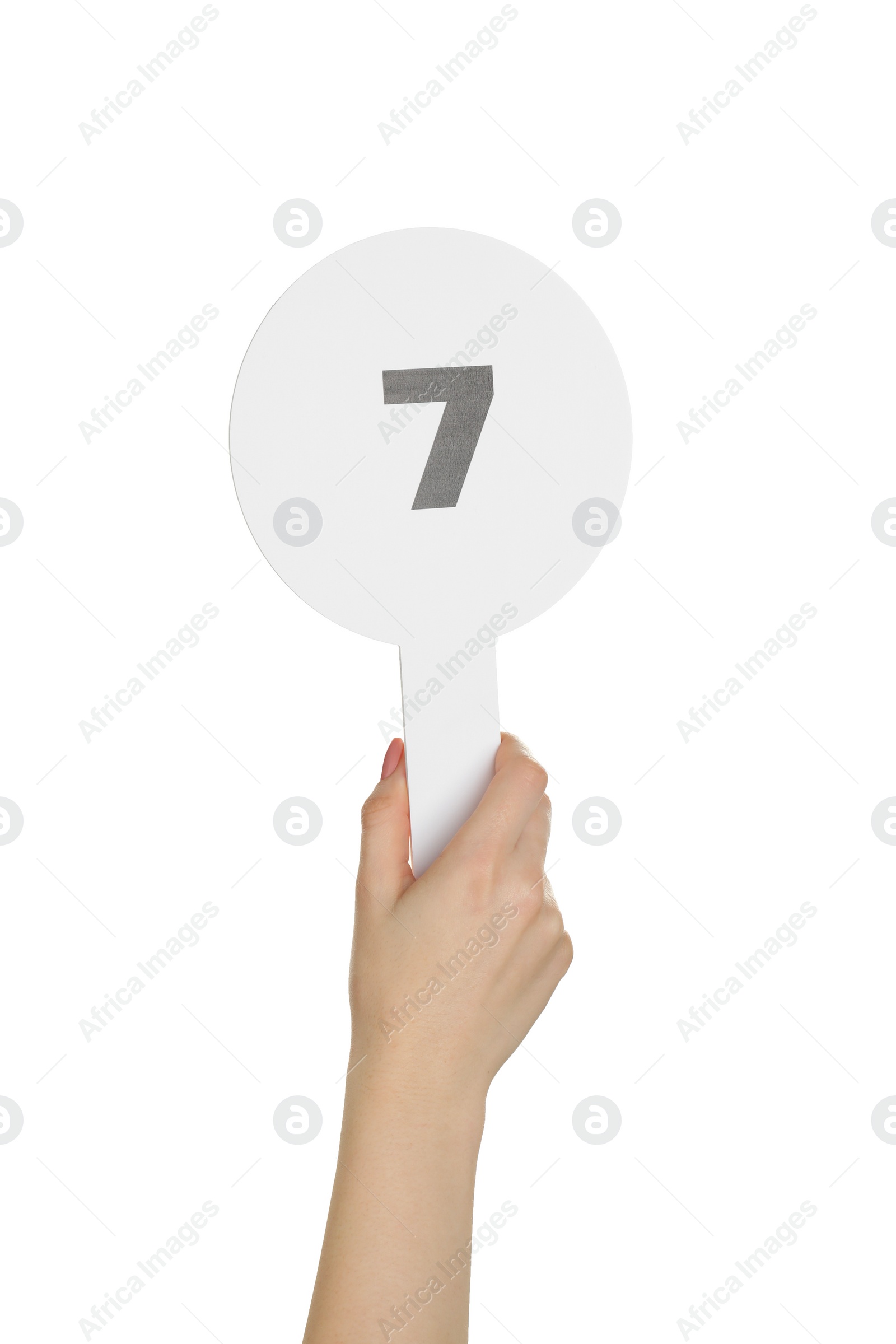 Photo of Woman holding auction paddle with number 7 on white background, closeup