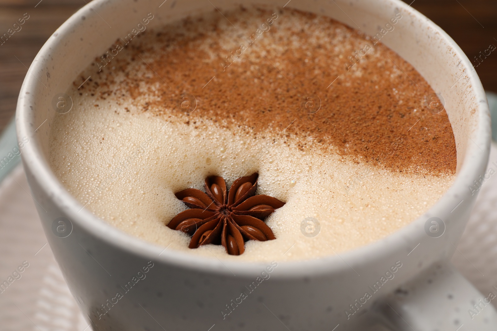 Photo of Cup of delicious eggnog with anise, closeup