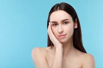 Photo of Portrait of beautiful young woman on light blue background. Space for text