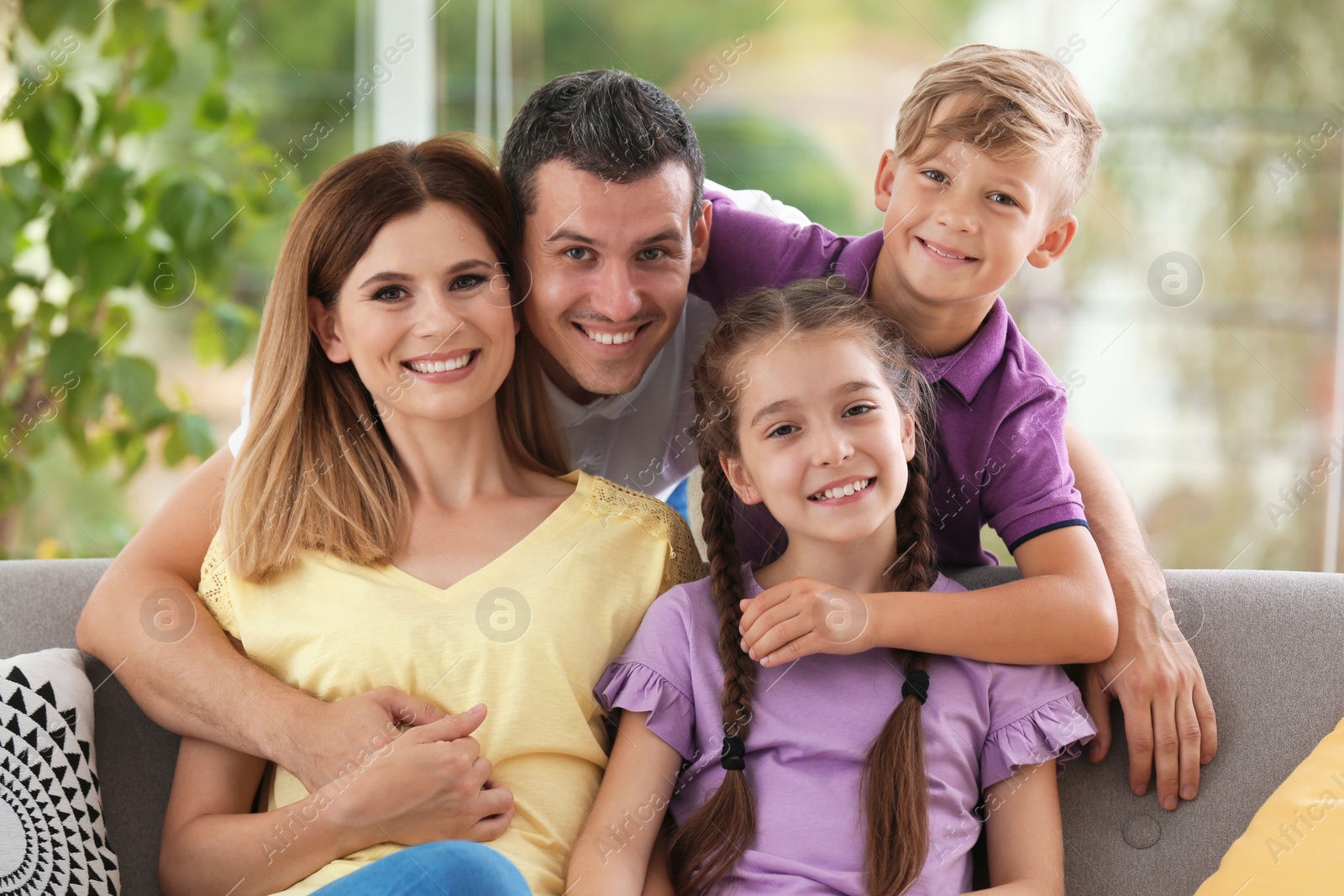 Photo of Happy family with cute children at home