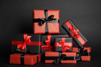 Photo of Many gift boxes on dark background. Black Friday