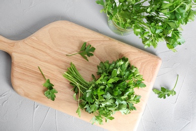 Flat lay composition with fresh green parsley on grey background