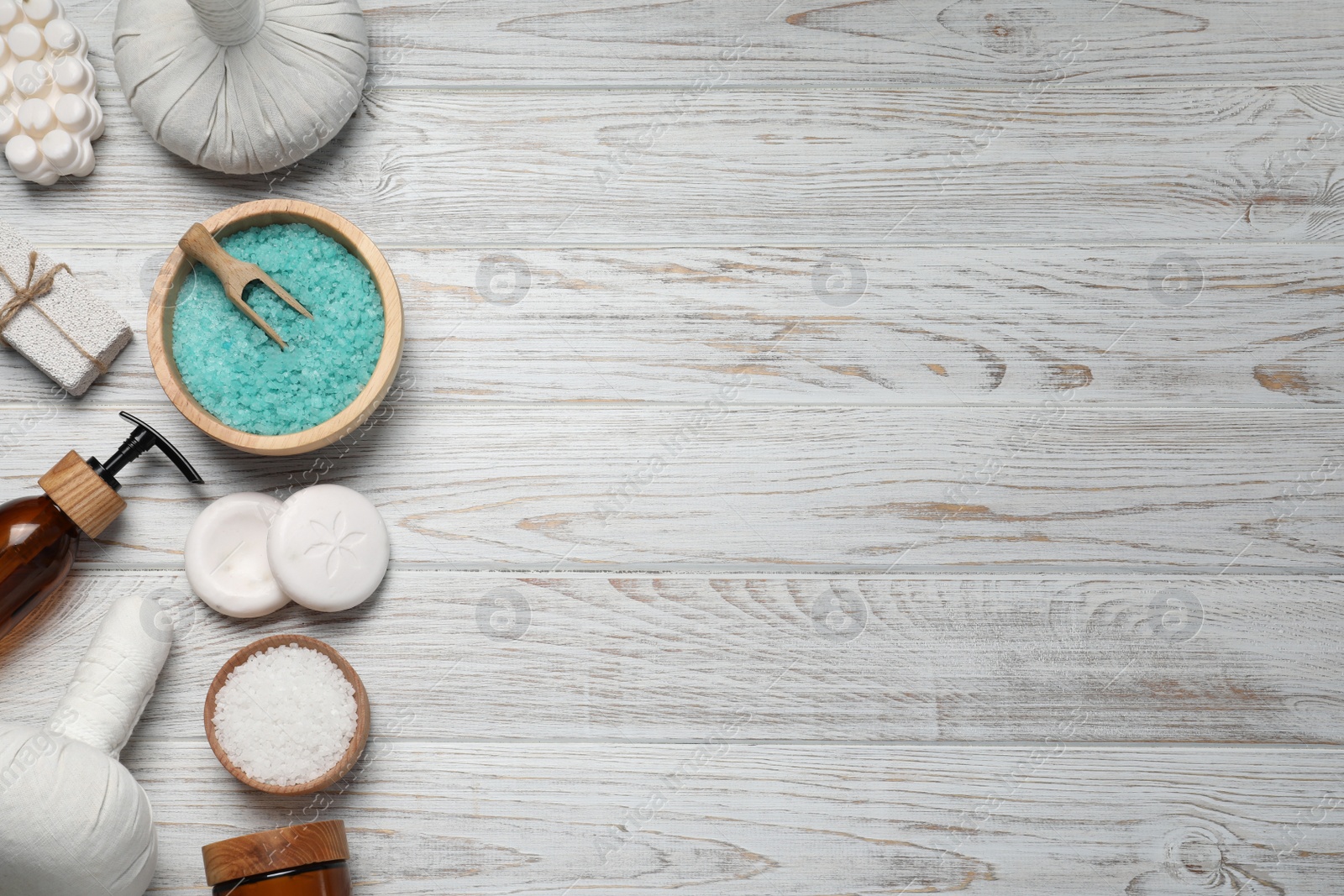 Photo of Flat lay composition of herbal bags and spa products on white wooden table, space for text