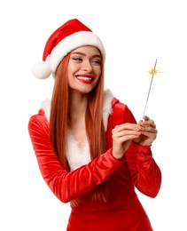 Photo of Young woman in red dress and Santa hat with burning sparkler on white background. Christmas celebration