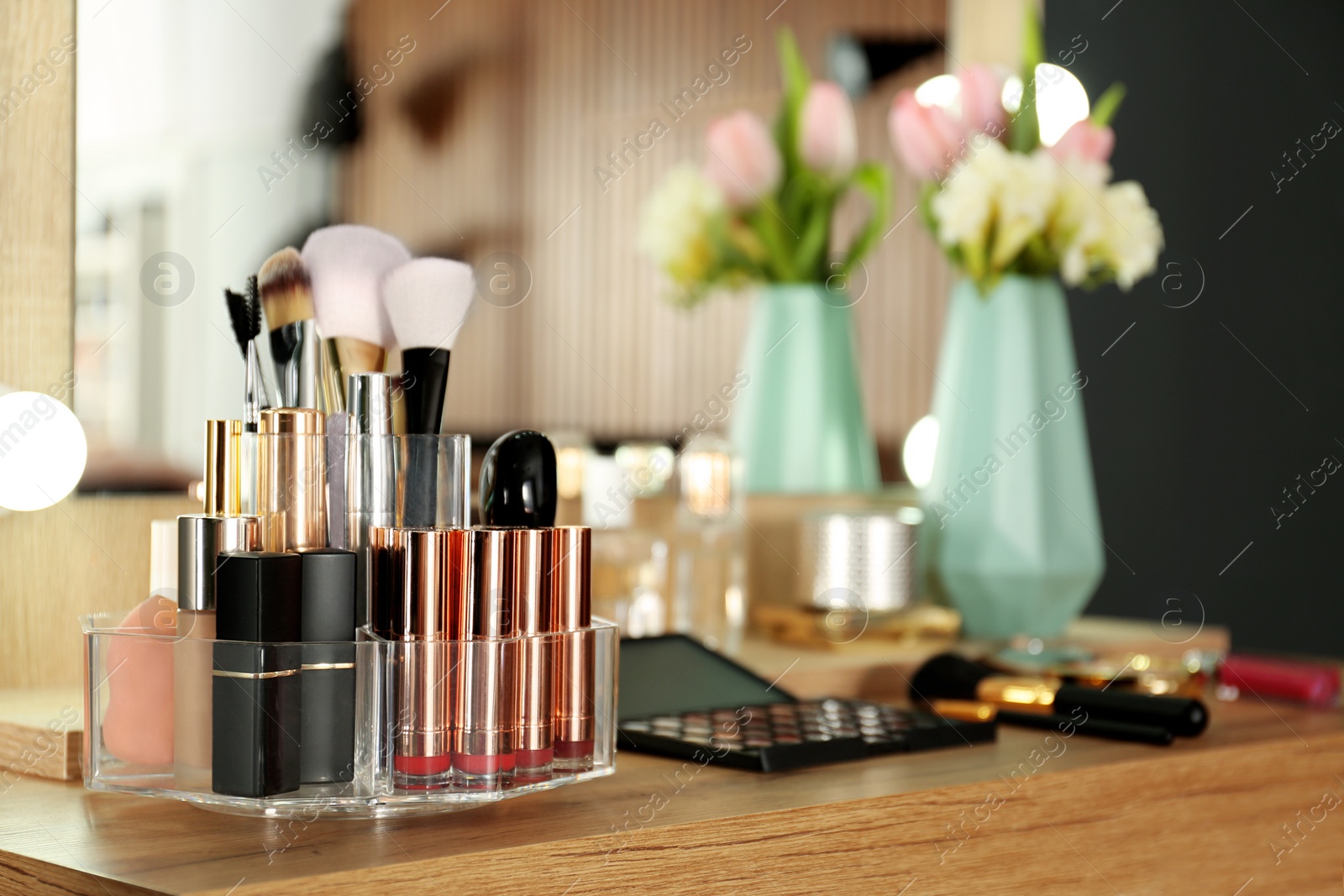 Photo of Dressing table with set of luxury cosmetic products. Interior element