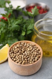 Aromatic peppercorns and different fresh ingredients for marinade on grey table