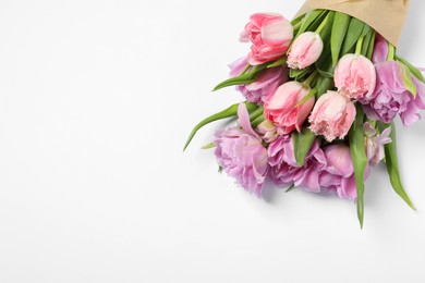 Beautiful bouquet of colorful tulip flowers on white background, top view. Space for text