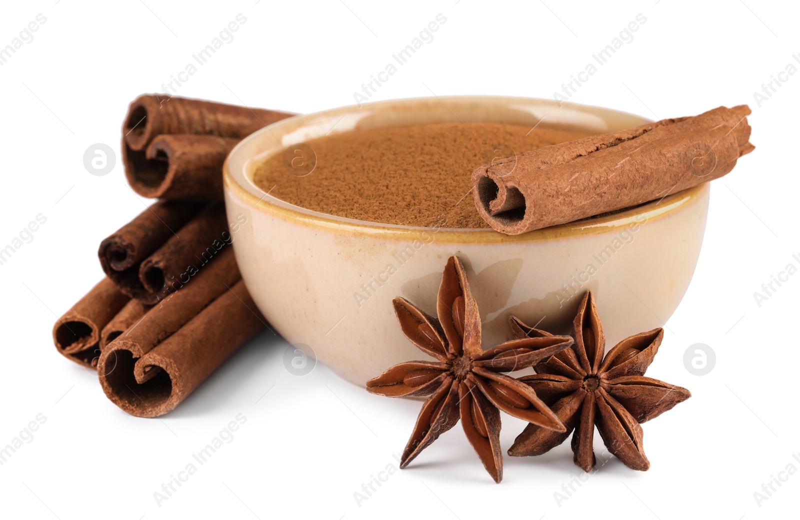 Photo of Dry aromatic cinnamon sticks, powder and anise stars isolated on white