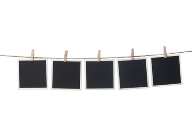 Clothespins with empty instant frames on string against white background. Space for text