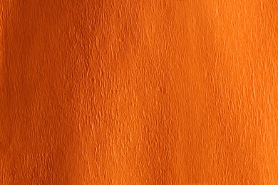 Photo of Orange textured surface as background, closeup view