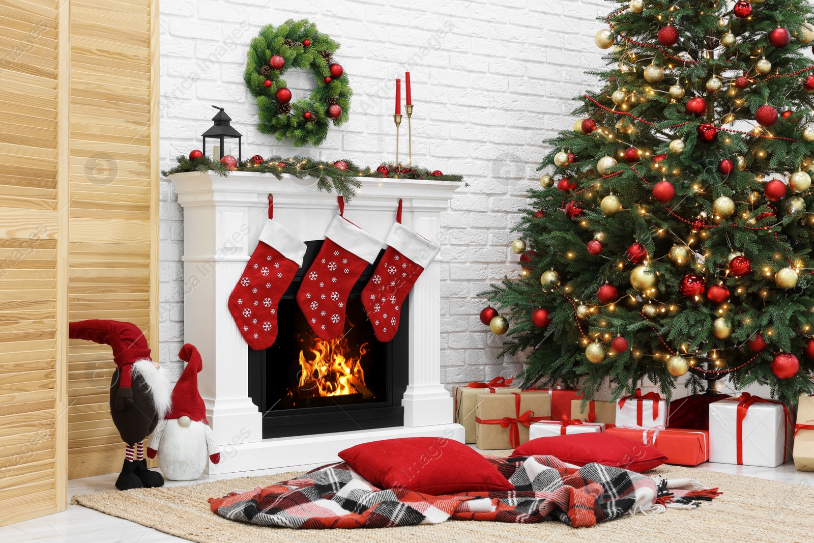 Photo of Cosy room with tree and fireplace decorated for Christmas. Interior design