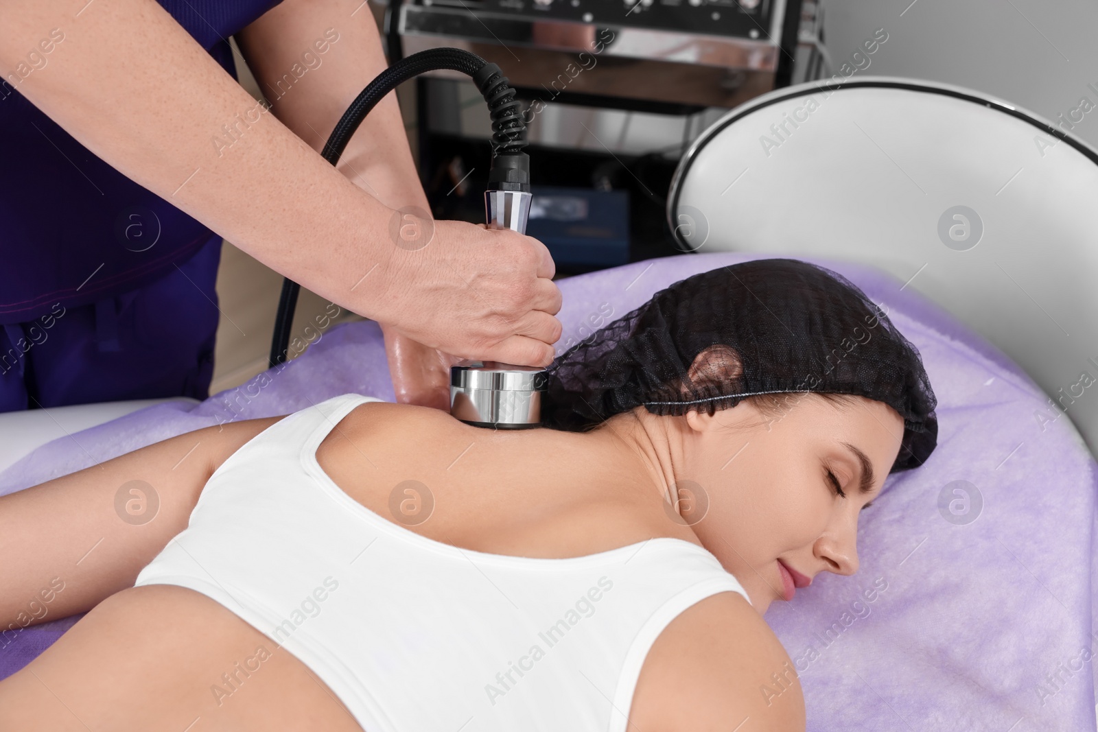 Photo of Woman undergoing radio frequency lifting procedure in beauty salon, closeup