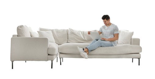 Man with laptop on comfortable sofa against white background