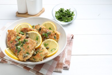 Delicious chicken piccata on white wooden table. Space for text