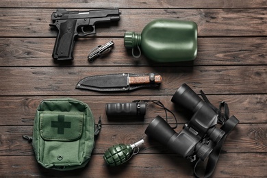 Set of military outfit on wooden background, flat lay