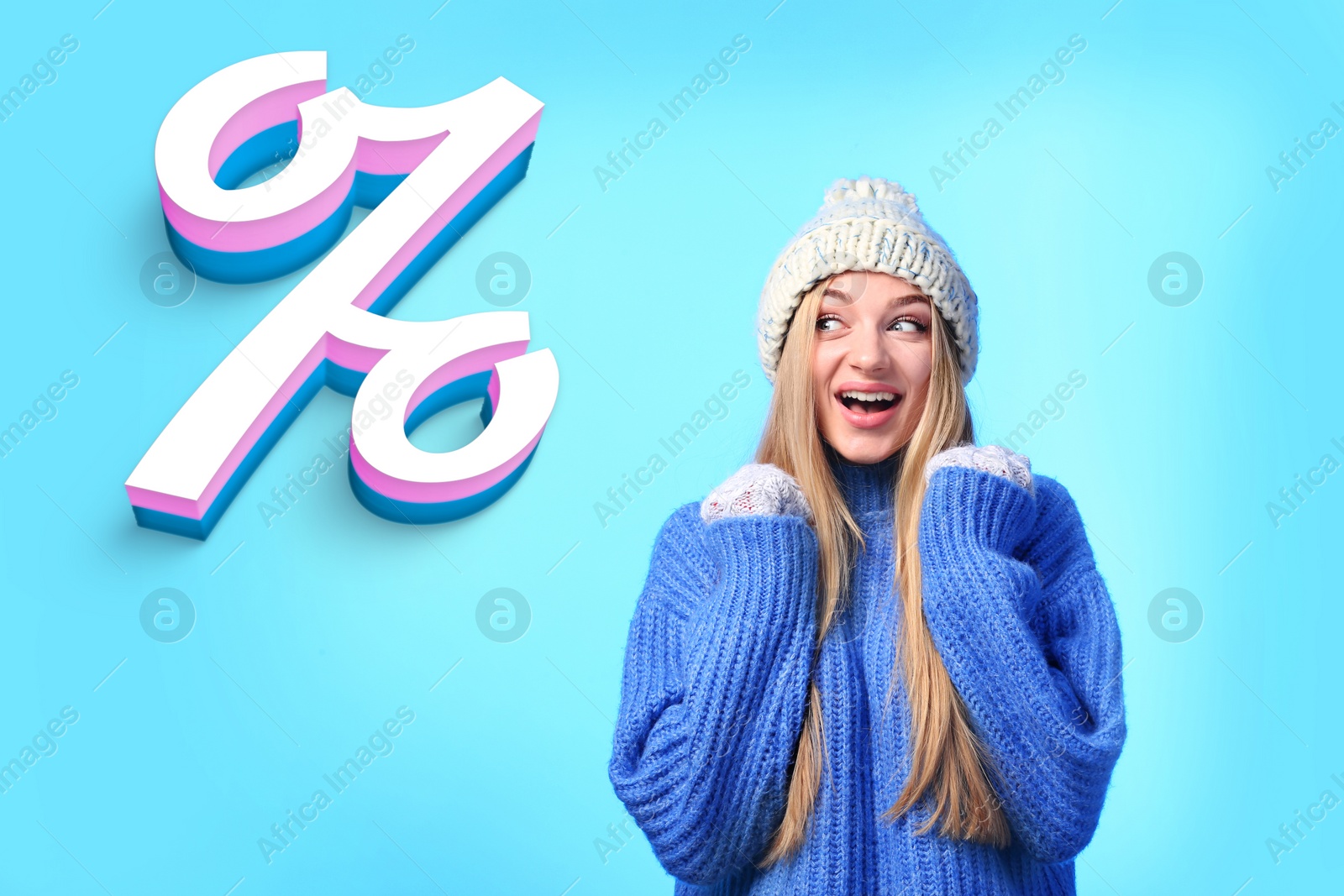Image of Discount offer. Emotional woman in warm sweater and hat looking at percent sign on light blue background