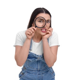 Photo of Confused young woman looking through magnifier glass on white background