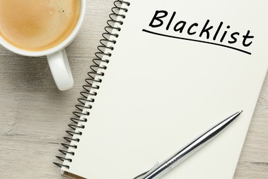 Image of Word Blacklist written in notepad and coffee on wooden background, flat lay