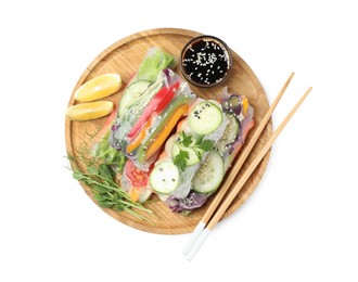 Many different delicious rolls wrapped in rice paper and soy sauce isolated on white, top view