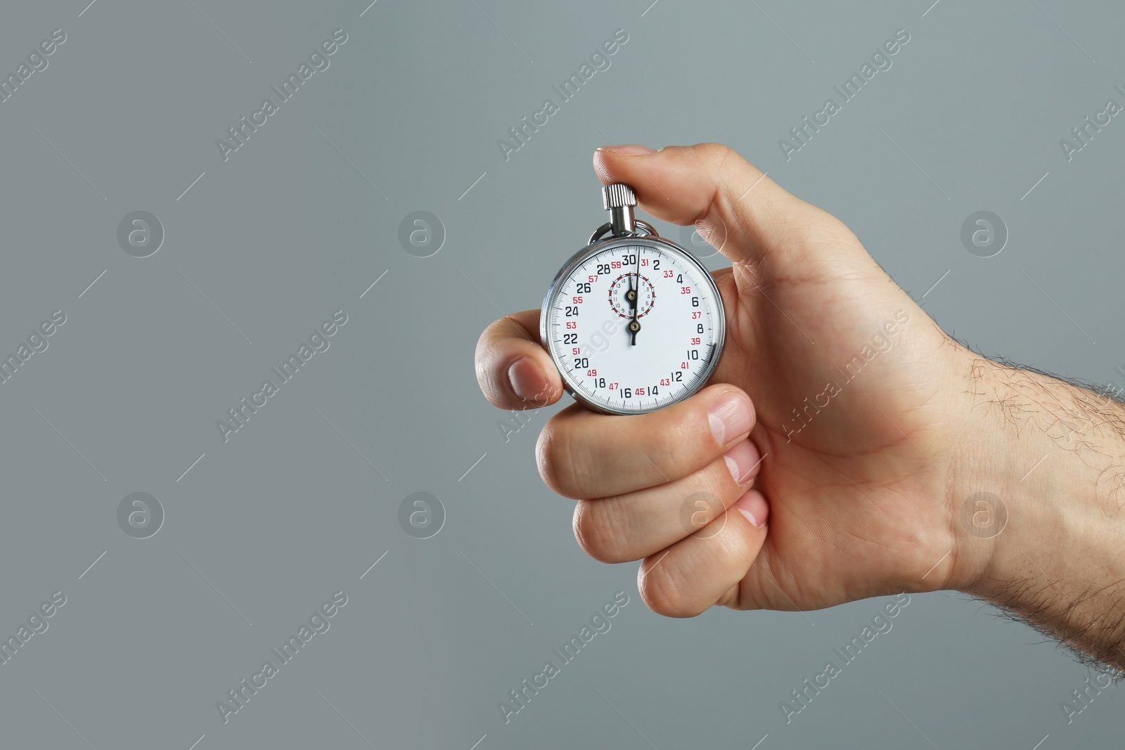 Photo of Man holding vintage timer on grey background, closeup. Space for text