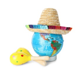 Photo of Globe with Mexican sombrero hat and maracas isolated on white