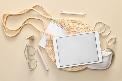 Flat lay composition with modern tablet on beige background. Space for text