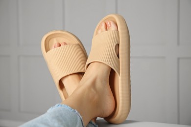 Woman wearing comfortable rubber slippers indoors, closeup