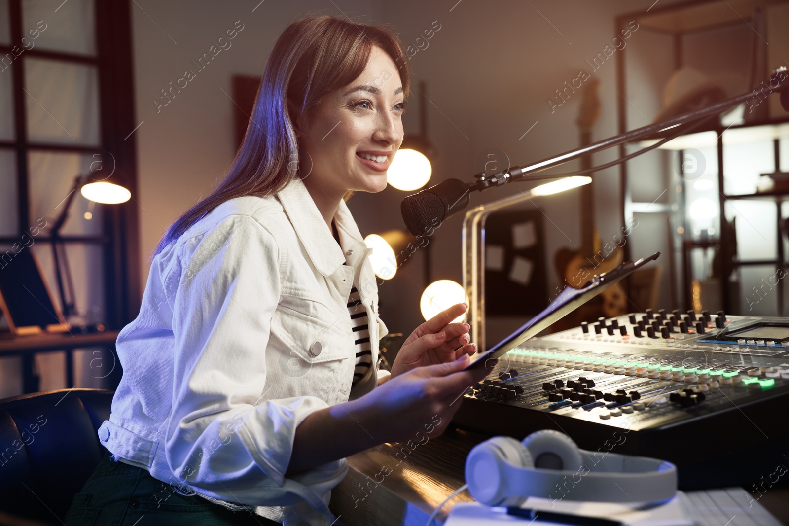 Photo of Woman working as radio host in modern studio