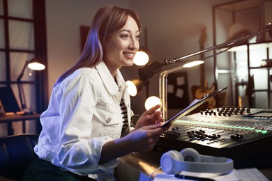 Photo of Woman working as radio host in modern studio