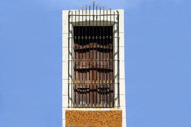 Photo of Beautiful window with grills on building, view from outdoors