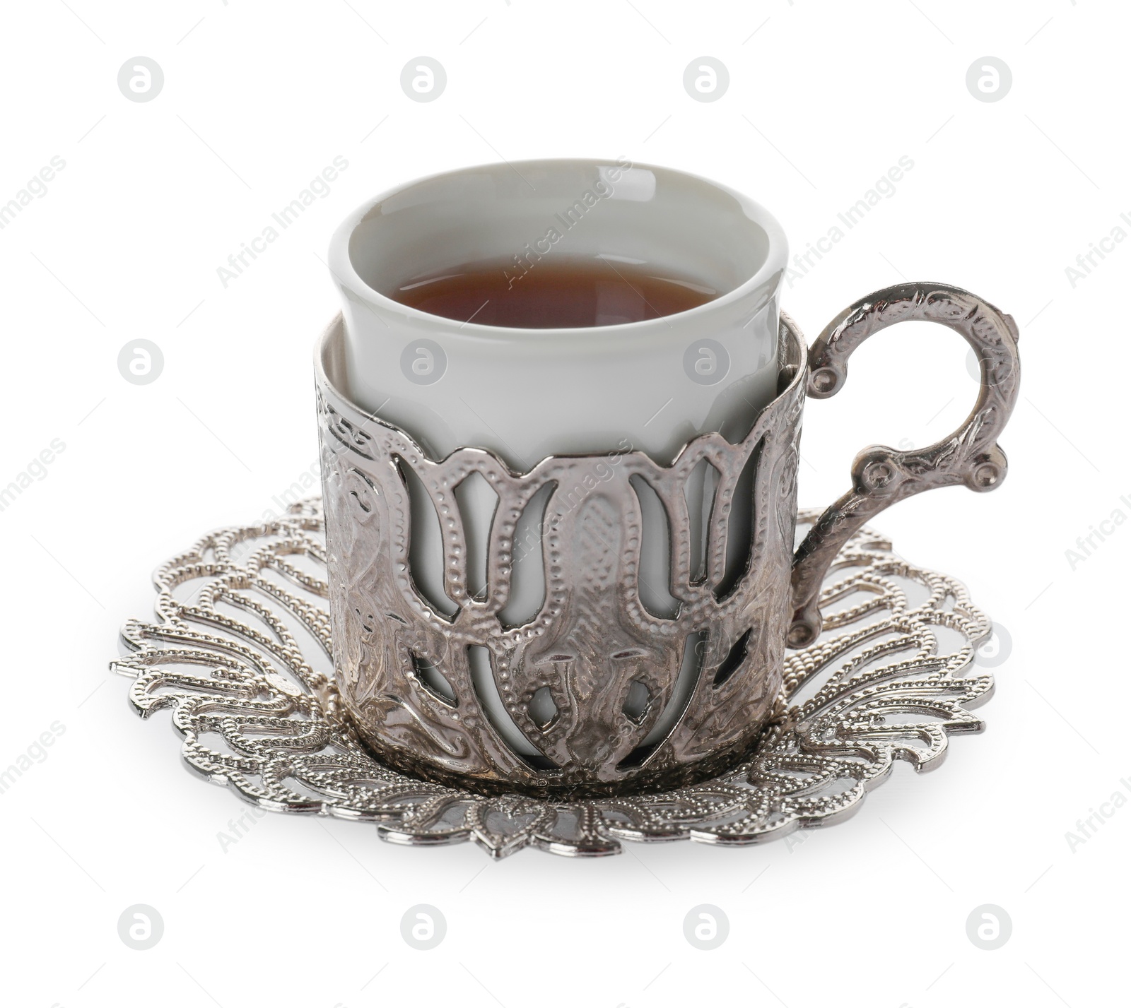 Photo of Glass of traditional Turkish tea in vintage holder isolated on white