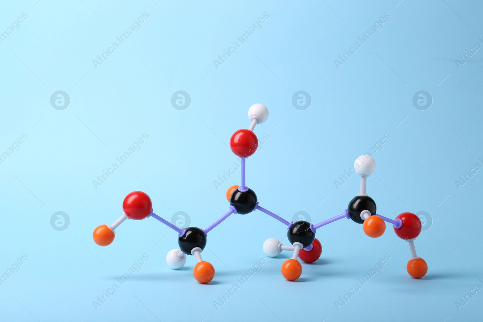 Photo of Molecule of sugar on light blue background. Chemical model