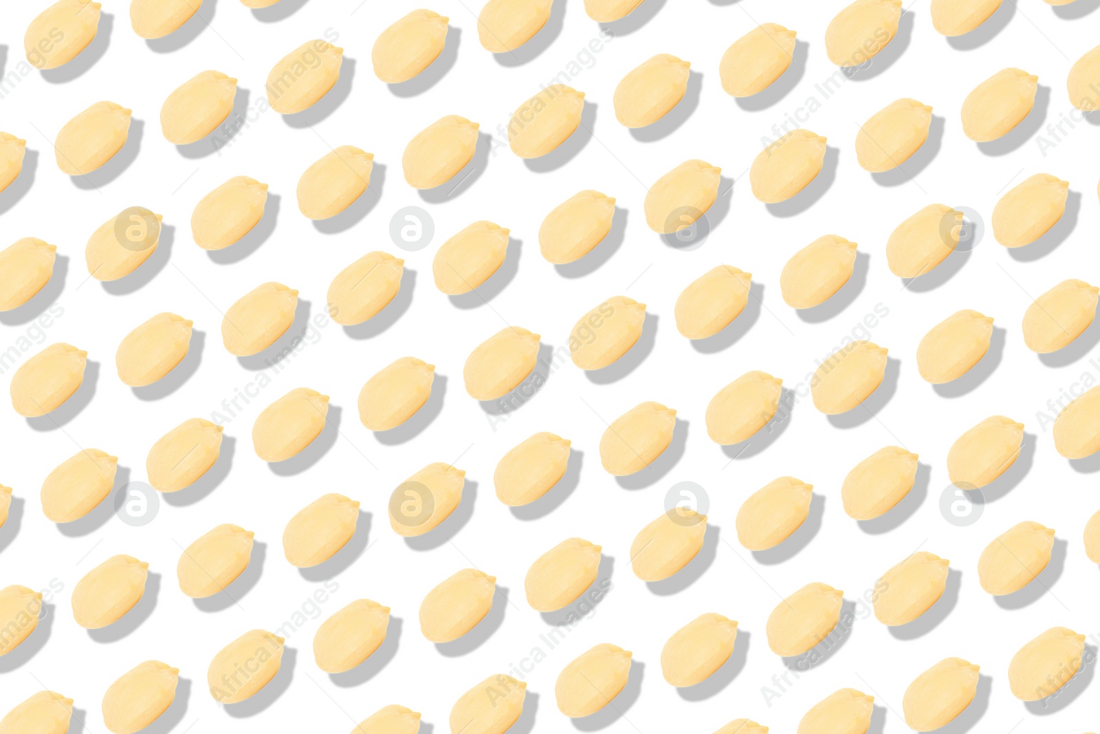 Image of Pattern of peeled peanuts on white background