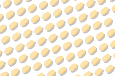 Pattern of peeled peanuts on white background