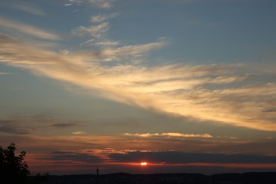 Photo of Picturesque view of cityscape and beautiful sky with clouds at sunset