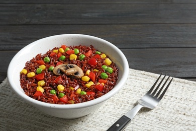 Photo of Bowl with cooked brown rice served on table. Space for text