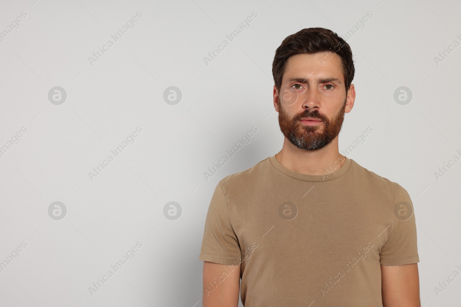 Photo of Portrait of handsome bearded man on white background