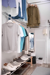 Modern dressing room with different stylish clothes and accessories