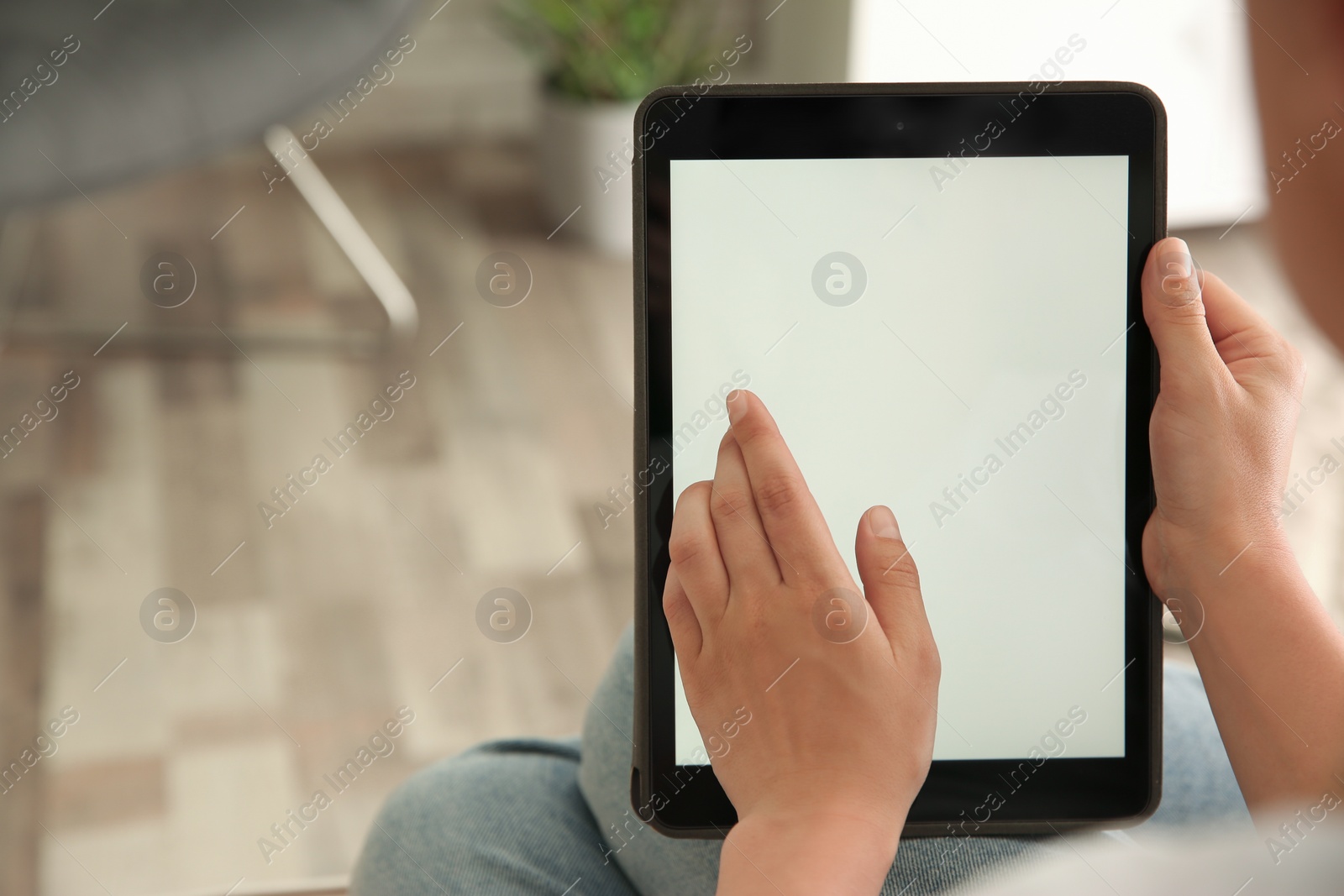 Photo of Woman working with modern tablet indoors, closeup. Space for design